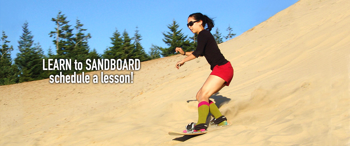 Young woman taking a sandboarding lesson.